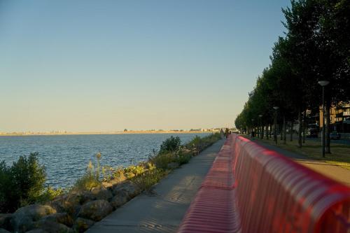 a sidewalk next to a body of water at The Water Studio in Amsterdam