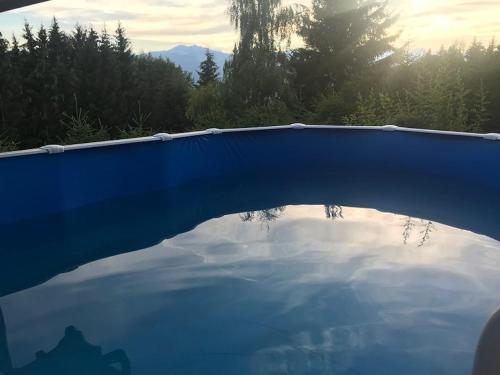 a reflection of the sky in a pool of water at Chalet traditionnel avec jacuzzi extérieur in Bex