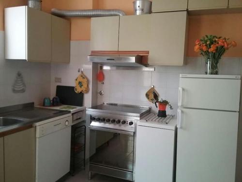 a kitchen with a stove and a white refrigerator at Mascagni Rooms in Florence