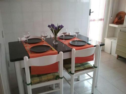 a dining room table with two chairs with wine glasses at Mascagni Rooms in Florence