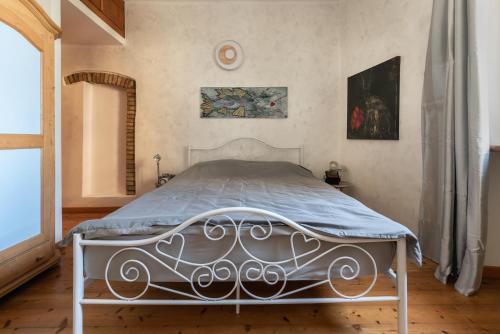 a bedroom with a white bed with a blue comforter at Rooms Relais Art Borgocastello3 in Gorizia