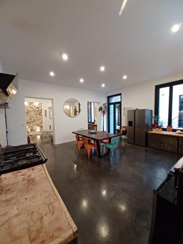 Il comprend un grand salon avec une table et une cuisine. dans l'établissement L'appartement au cœur de Sète., à Sète