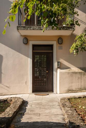 a door to a building with a balcony on it at Rooms Relais Art Borgocastello3 in Gorizia