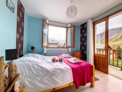 a bedroom with a bed and a large window at Chalet Saint-Martin-de-Belleville, 5 pièces, 6 personnes - FR-1-344-1051 in Saint-Marcel