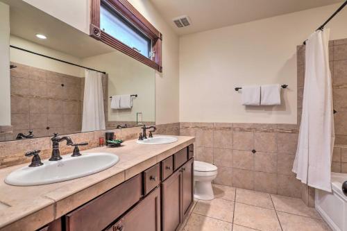 a bathroom with two sinks and a toilet at Cozy Central Glenwood Springs Condo with 2 Decks! in Glenwood Springs