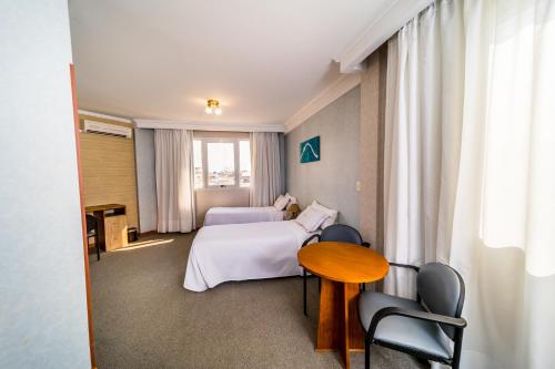 Ένα ή περισσότερα κρεβάτια σε δωμάτιο στο Gran Hotel Verona