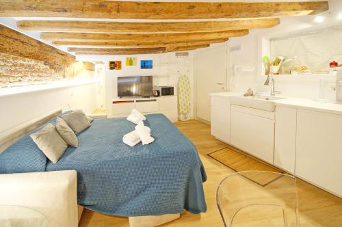 a bedroom with a blue bed with a teddy bear on it at DolceVita Apartments N. 506 Design in Venice