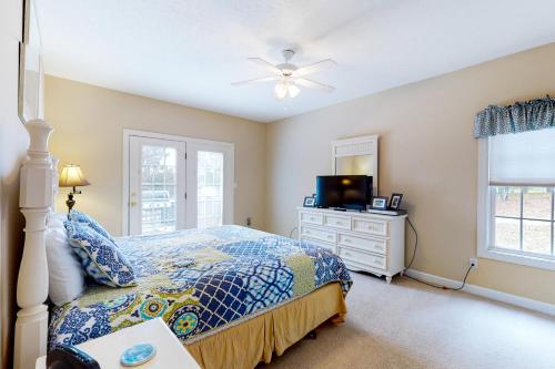 a bedroom with a bed and a tv in it at Orr at Waterways in Huddleston