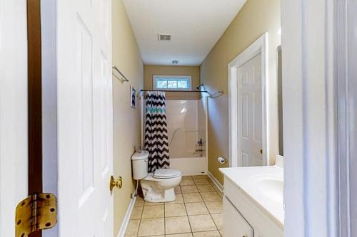 a bathroom with a toilet and a sink at Orr at Waterways in Huddleston