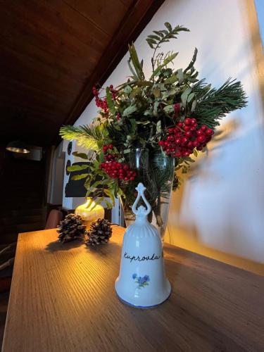 a vase of flowers sitting on top of a table at Horská bouda KUPROVKA in Strážné