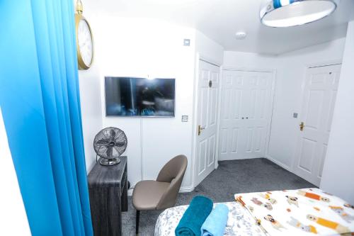 a bedroom with a bed and a tv on a wall at SureBillionaire Homes in Thamesmead