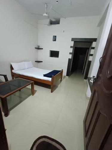 a bedroom with a bed and a couch in a room at M Cube Service Apartments in Sakleshpur