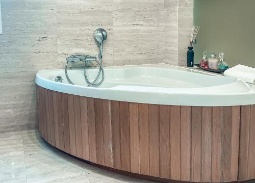 a bath tub in a bathroom with a wooden floor at The Marbella Heights Boutique Hotel in Marbella