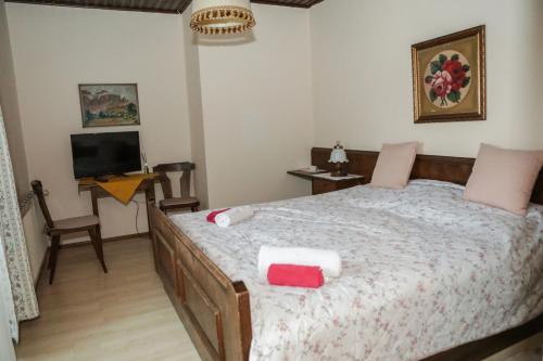 a bedroom with a bed with two towels on it at Pension Welserhof in Wilfersdorf
