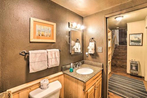 a bathroom with a sink and a toilet at Rustic Condo with Patio Walk to Angel Fire Resort! in Angel Fire
