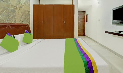 a bedroom with a bed with a colorful blanket at Treebo Sky 5 in Chandīgarh