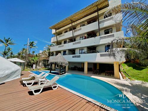a resort with a swimming pool and a building at DELUX BEIRA-MAR NATAL Flat in Natal