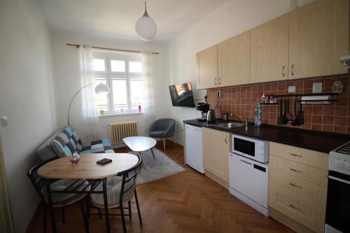 a kitchen with a table and a small table and chairs at Apartmán Pražská in Jablonec nad Nisou
