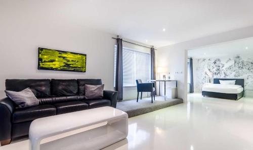 a living room with a couch and a bed at Designhotel Youngstar in Mannheim