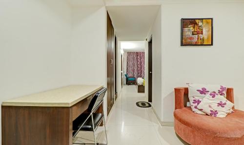 a living room with a desk and a chair at Treebo Sky 5 in Chandīgarh