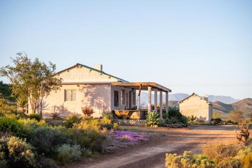 a house in the middle of a dirt road at Fossil Hills in McGregor