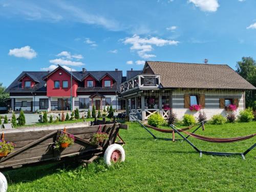 a house with a horse drawn cart in front of it at Ostoja Karkonoska in Podgórzyn