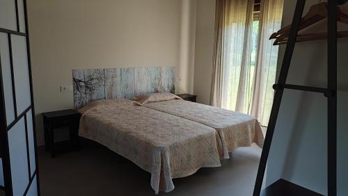 a bedroom with a bed and a large window at Mi Casa en Guriezo in Angostina