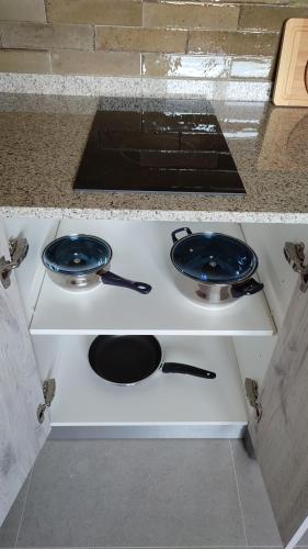 a stove with two pans on top of it at Mi Casa en Guriezo in Angostina