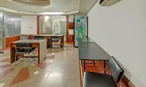 an office with chairs and a table and a counter at Treebo Sky 5 in Chandīgarh