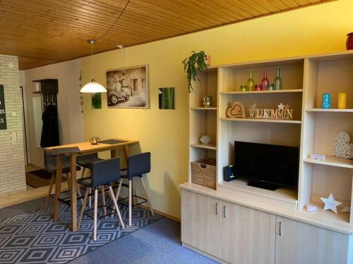 a dining room with a table and a television in a room at Ferienwohnung Chrisi im Kulmhof in Tauplitz