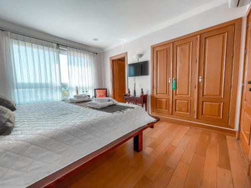 a bedroom with a large bed and a large window at The Marbella Heights Boutique Hotel in Marbella
