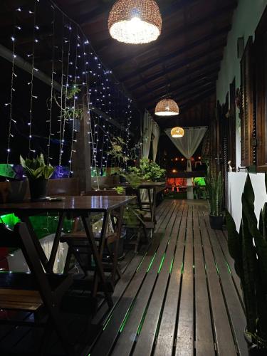 a restaurant with tables and potted plants and lights at HTL PERSONALIZADA BUZIOS in Búzios