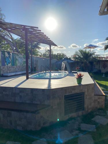 a pool in a backyard with a playground at HTL PERSONALIZADA BUZIOS in Búzios