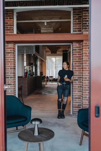 a woman standing in the doorway of a brick building at Südspeicher in Kappeln
