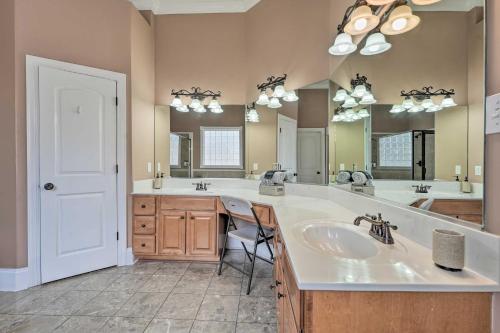 a bathroom with two sinks and a large mirror at Cordova Home with Pool Table, 17 Mi to Memphis Zoo! in Cordova