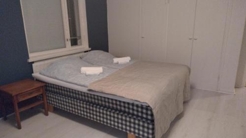 a small bed in a room with a window at Rauma City Apartments in Rauma