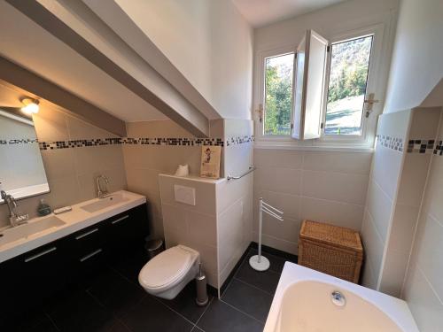 a white bathroom with a sink and a toilet at Large villa for 20 guests on large estate with private pool and tennis court Big conference room with facilities VILLAITALY EU in Cairo Montenotte