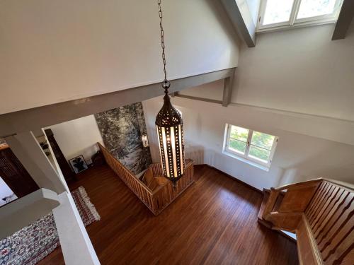 an overhead view of a living room with a chandelier at Large villa for 20 guests on large estate with private pool and tennis court Big conference room with facilities VILLAITALY EU in Cairo Montenotte