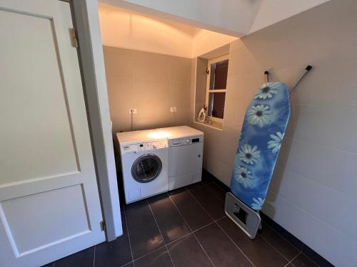 a small laundry room with a washer and dryer at Large villa for 20 guests on large estate with private pool and tennis court Big conference room with facilities VILLAITALY EU in Cairo Montenotte
