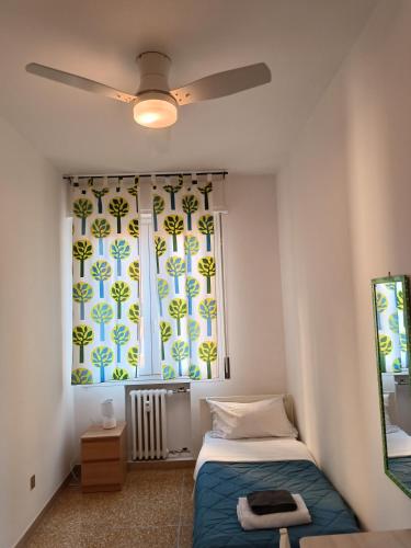 a bedroom with a bed and a large window at Affittacamere Pratello 97 in Bologna