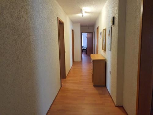 a hallway of an apartment with white walls and wooden floors at Pension für Monteure in Leisnig in Leisnig