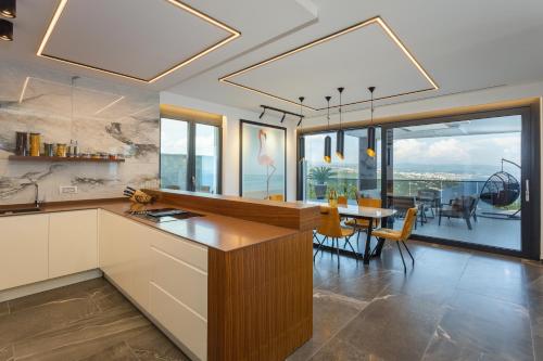 a kitchen with a table and a dining room at Villa Platinium in Opatija