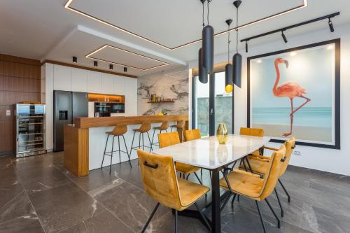a dining room and kitchen with a table and chairs at Villa Platinium in Opatija