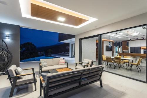 a living room with a couch and chairs at Villa Platinium in Opatija