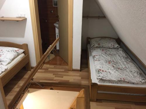 a room with two bunk beds and a staircase at Vikendica RAJ in Travnik