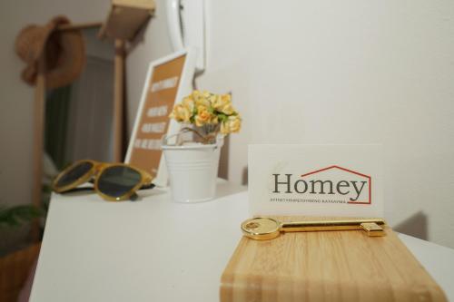 a box with the word honey sitting on a table with sunglasses at Homey Edessa in Edessa