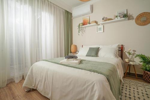 a bedroom with a bed with a green blanket at Homey Edessa in Edessa