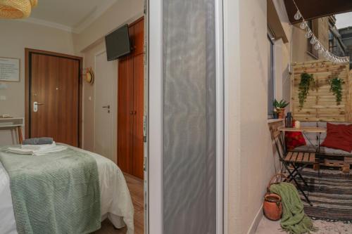 a hallway with a table and a chair in a room at Homey Edessa in Edessa