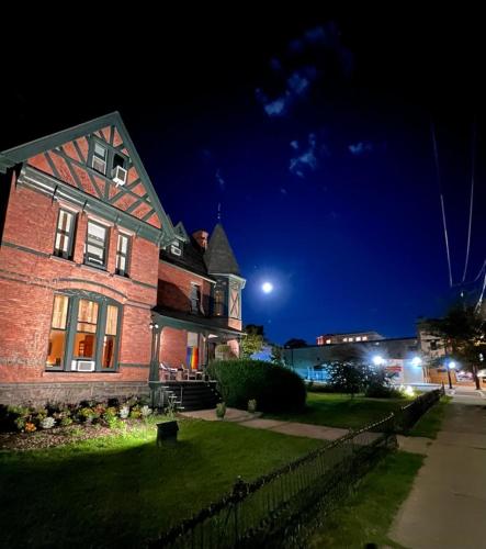 a brick house at night with the moon in the sky at William Henry Miller Inn in Ithaca