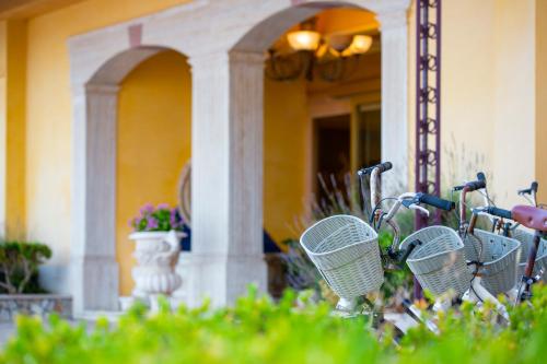 a row of bikes parked in front of a building at Hotel Villa Romana in Porto Empedocle